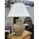 A large pottery table lamp and shade
