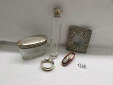 A silver watch case front, a silver napkin ring, a cased silver topped thimble,
