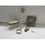 A silver watch case front, a silver napkin ring, a cased silver topped thimble,