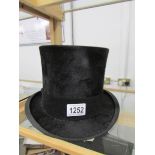 A good quality Henry Heath top hat. approximate size 6 7/8ins.