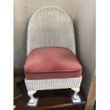A lloyd loom bedroom chair with spring seat