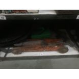 A shelf of car accessories including 2 scissor jacks, an old trolley jack,
