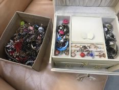 A cream jewellery box with miscellaneous jewellery and one further box with jewellery