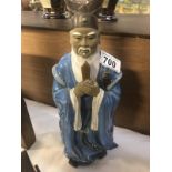 A pottery Chinese deity figure