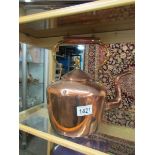 A Victorian copper kettle.