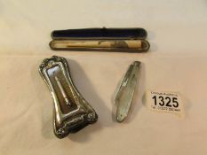 A silver framed thermometer, a silver and mother of pearl fruit knife and a cased cheroot holder.