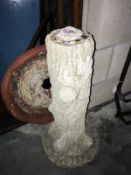 A concrete bird bath