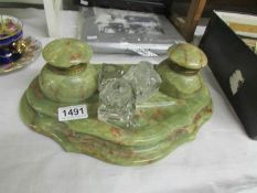 A heavy onyx desk stand and 3 glass inkwells (missing tops).