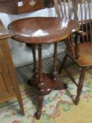 A carved mahogany table with shaped top;