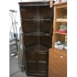 A dark oak corner cupboard