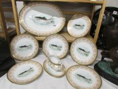 A set of fish plates comprising platter, 6 plates and sauce boat.