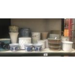 A shelf of ceramic pots & vases