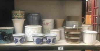 A shelf of ceramic pots & vases