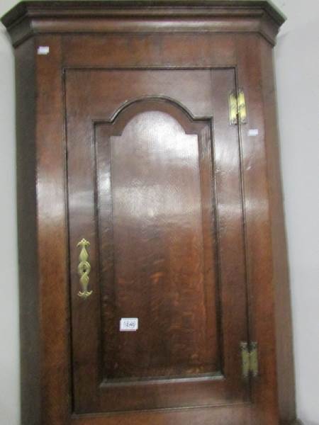 An oak corner cupboard.