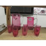2 cranberry glass jugs and 6 beakers.