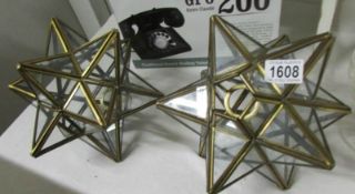 A pair of brass and glass star shaped hall lamp shades.