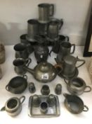 A mixed selection of pewter ware including tankards