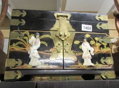 A good quality lacquered jewellery box with brass fittings and mother of pearl figures.
