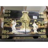 A good quality lacquered jewellery box with brass fittings and mother of pearl figures.