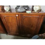 A mahogany 2 door cupboard.