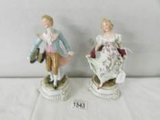 A pair of 19th century porcelain figures, 19 cm tall.