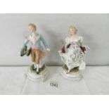 A pair of 19th century porcelain figures, 19 cm tall.