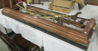 A copper curb together with a set of brass fire irons and fire dogs.