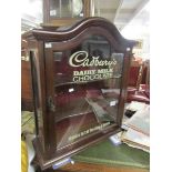 A cabinet with Cadbury sign to glass.