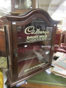 A cabinet with Cadbury sign to glass.