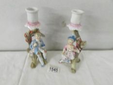 A pair of 19th century figural candle sticks.