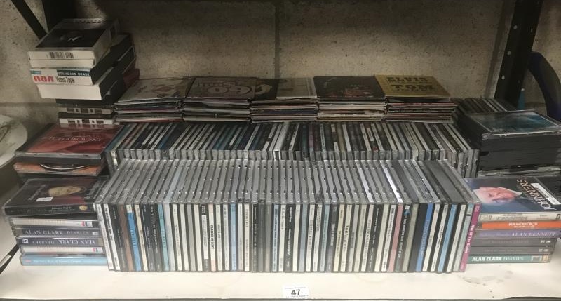 A collection of CD's with some cassette tapes