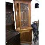 An astragal glazed oak corner cupboard