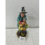 A Royal Doulton figurine 'The Mask Seller', HN2103.