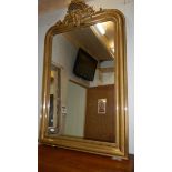 A gilt framed overmantel mirror with arched top.