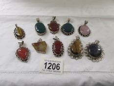 10 assorted stone set silver pendants including carnelian, rose quartz, tigers' eye etc.