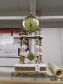 A Capo di monte clock with key and pendulum.