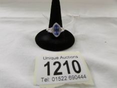 A 14ct white gold ring set tanzanite and pava diamonds, marked 14k and CJ. Size S half.