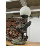 A table lamp in the form of a cherub riding Pegasus with crackle glass globe shade.