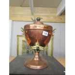 A copper samovar urn with brass tap.