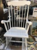 A white painted rocking chair