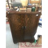 A 1930's oak bedroom cupboard