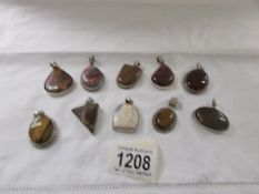 10 assorted stone set silver pendants including agate, tiger's eye, carnelian etc.