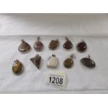 10 assorted stone set silver pendants including agate, tiger's eye, carnelian etc.