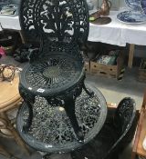 A painted metal garden table and 2 chairs