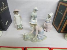 4 NAO figurines including girl with dog, girl with rabbit etc.