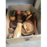 A box of wooden items including fruit