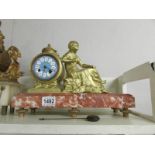 A French gilt mantel clock on marble base and surmounted figure (not working).