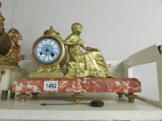 A French gilt mantel clock on marble base and surmounted figure (not working).