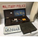 A quantity of American car number plates, a military police sign & RAC badge etc.