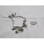 An unusual silver bracelet with 8 charms, approximately 26.7 grams.